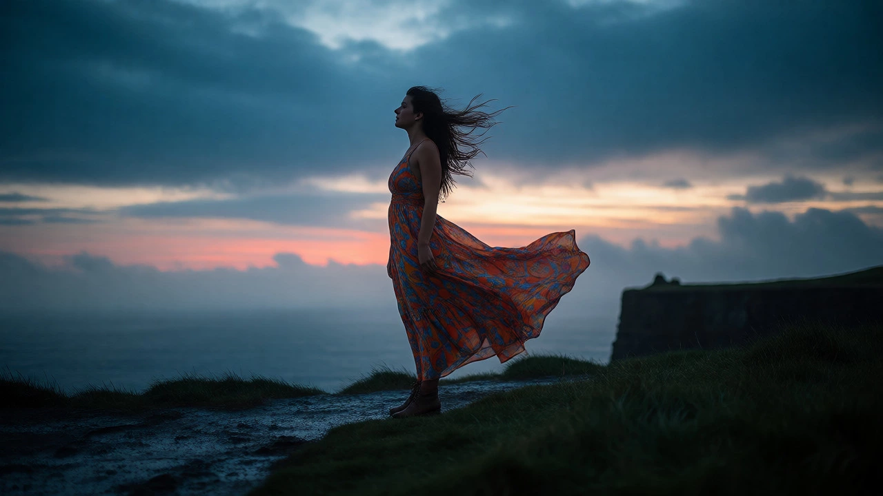 Woman in flowy maxi dress on windy Cliffs of Moher at sunset